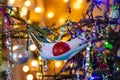 Christmas tree decorated with a medical mask with christmas ball in it, defocused lights on the background Royalty Free Stock Photo