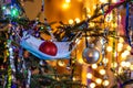 Christmas tree decorated with a medical mask with christmas ball in it, defocused lights on the background Royalty Free Stock Photo