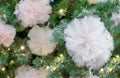 Christmas tree decorated with garland and white fatin bows Royalty Free Stock Photo
