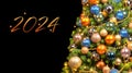 christmas tree decorated with gold and blue balls and garlands on a black background Royalty Free Stock Photo