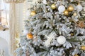 room interior with Christmas tree decorated with golden balls toys on blurred, sparkling and fabulous fairy tale background with Royalty Free Stock Photo