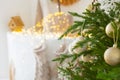 room interior with Christmas tree decorated with golden balls toys on blurred, sparkling and fabulous fairy tale background with Royalty Free Stock Photo