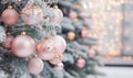 Christmas tree decorated with pink and silver christmas balls, festive blurred background with bokeh Royalty Free Stock Photo