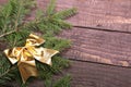 Christmas tree decorated red bow, branches and cones on wooden background Royalty Free Stock Photo