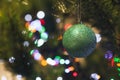 Christmas tree decorated with shiny green sphere and bokeh in the background Royalty Free Stock Photo