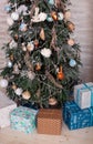 Christmas  tree decorated with toys, balls and lights glowing garlands in living room. Beautiful decorated Christmas tree with gif Royalty Free Stock Photo