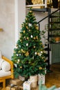 The Christmas tree is decorated with toys, dried lemons or oranges, Christmas gifts and garlands in the living room Royalty Free Stock Photo