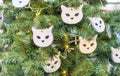 Christmas tree decorated with toys in the form of cats muzzles