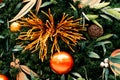 Christmas tree decorated in tropical style with golden and orange ornaments ball. Close up Royalty Free Stock Photo
