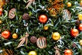 Christmas tree decorated in tropical style with golden and orange ornaments ball. Close up Royalty Free Stock Photo