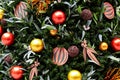 Christmas tree decorated in tropical style with golden and orange ornaments ball. Close up Royalty Free Stock Photo