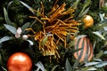 Christmas tree decorated in tropical style with golden and orange ornaments ball. Close up Royalty Free Stock Photo
