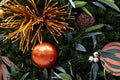 Christmas tree decorated in tropical style with golden and orange ornaments ball. Close up Royalty Free Stock Photo