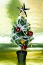 Christmas tree decorated wiith ornaments in rich gold shiny background - full length