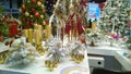 Christmas tree decoration and ornament in holiday fair. Gold candlesticks and shiny silver decor. Traditional Xmas trade show. Hap