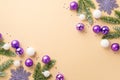 Christmas tree decorations concept. Top view photo of violet and white baubles snowflake ornaments fir branches in snow and purple Royalty Free Stock Photo