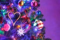 Christmas tree with decorations and purple illumination Royalty Free Stock Photo