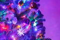 Christmas tree with decorations and purple illumination Royalty Free Stock Photo