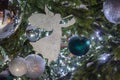 Christmas tree decorations: the silhouette of an white paper angel, silver and blue balls and with sparkling garlands Royalty Free Stock Photo