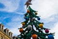 Christmas tree with decorations is spinning in the street