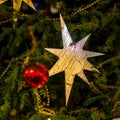 Christmas tree with decorations, christmas star, balls. Selective focus. Abstract festive background. Bright backdrop