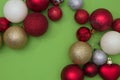 Christmas tree decorations in various colors on a green background with copy space. New Year`s scene setting