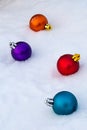 Christmas tree decorations on white snow. Multi-colored balls Royalty Free Stock Photo
