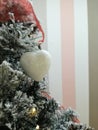 Christmas tree decotared with white sparkling heart and lights. Royalty Free Stock Photo