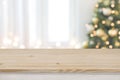 Christmas tree defocused background with wooden table in front
