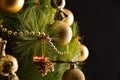 Christmas tree detail decorated with golden ornaments black background