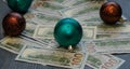 A Christmas tree from dollars money on a wooden background.