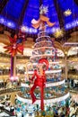 The Christmas tree and the Elf at Galeries Lafayette in Paris, France Royalty Free Stock Photo