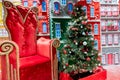 Christmas tree and empty red Santa chair