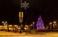 Christmas tree and festive light poles at night time Royalty Free Stock Photo