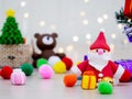 A Christmas tree filled with gifts and colorful balls close up