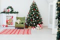 Christmas tree with fireplace interior of white room new year decoration garland gifts Royalty Free Stock Photo