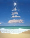 Christmas tree formed in the sky with clouds and sun. Royalty Free Stock Photo