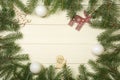 Christmas tree frame branches, balls and christmas toys on wooden background with copy space. Horizontal template for design