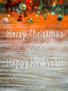 Christmas tree garland with decoration on wooden board. Bright Christmas and New Year background with text Merry Royalty Free Stock Photo