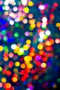 Christmas tree garland light. Colorful bokeh blurry decor on black background. Holiday wallpaper night glowing.