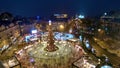 A Christmas tree decorated with garlands illuminates the Christmas fair at the Sofiyivska Square on Christmas Eve in Kyiv, Ukraine