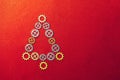 Christmas Tree gears on red textured background with copy-space Royalty Free Stock Photo