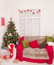 Christmas tree, gift boxes and sofa at home room Royalty Free Stock Photo
