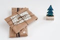 Christmas tree and gifts in craft paper, simple handmade present