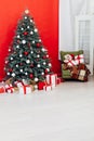 Christmas tree blue pine with gifts interior decor red background New Year winter holiday Royalty Free Stock Photo