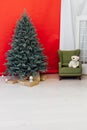 Christmas tree blue pine with gifts interior decor red background New Year winter holiday Royalty Free Stock Photo