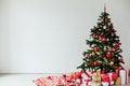 Christmas tree with gifts of red white interior decor for the new year Royalty Free Stock Photo