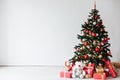Christmas tree with gifts of red white interior decor for the new year Royalty Free Stock Photo