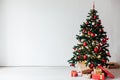 Christmas tree with gifts of red white interior decor for the new year Royalty Free Stock Photo