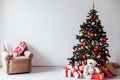 Christmas tree with gifts of red white interior decor for the new year Royalty Free Stock Photo